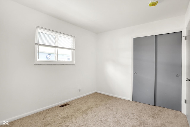 3809 Wildwood Dr, Indianapolis, IN 46239 - unfurnished bedroom with carpet, baseboards, and a closet