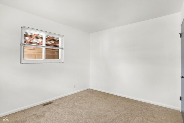 3809 Wildwood Dr, Indianapolis, IN 46239 - spare room featuring carpet and baseboards