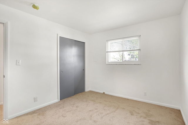 3809 Wildwood Dr, Indianapolis, IN 46239 - unfurnished bedroom featuring carpet flooring, a closet, and baseboards