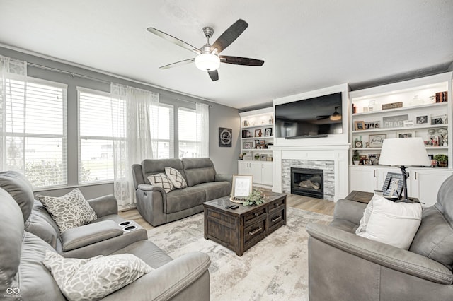 4644 Shelby Cir, Greenwood, IN 46143 - living area with a glass covered fireplace, light wood-type flooring, and ceiling fan