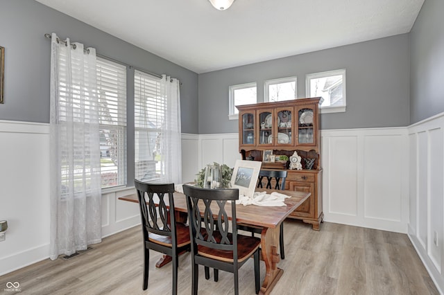 4644 Shelby Cir, Greenwood, IN 46143 - dining space with a decorative wall, visible vents, a wainscoted wall, and light wood-style floors
