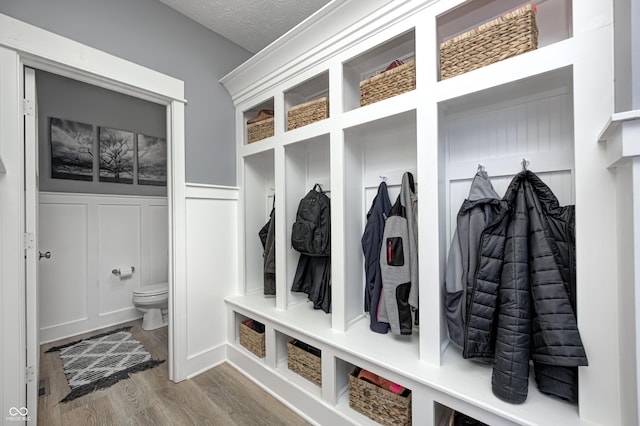 4644 Shelby Cir, Greenwood, IN 46143 - mudroom featuring a decorative wall, wood finished floors, and a wainscoted wall