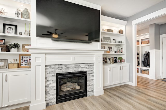 4644 Shelby Cir, Greenwood, IN 46143 - unfurnished living room featuring a fireplace, light wood-style floors, and a ceiling fan