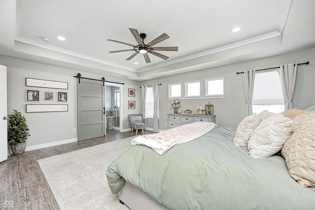 4644 Shelby Cir, Greenwood, IN 46143 - bedroom with recessed lighting, crown molding, a barn door, a raised ceiling, and wood finished floors