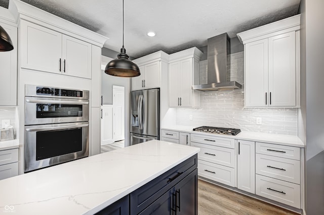4644 Shelby Cir, Greenwood, IN 46143 - kitchen with light wood-type flooring, recessed lighting, wall chimney exhaust hood, stainless steel appliances, and hanging light fixtures