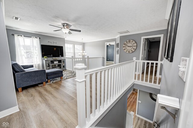 4644 Shelby Cir, Greenwood, IN 46143 - stairs with visible vents, ceiling fan with notable chandelier, wood finished floors, and a textured ceiling