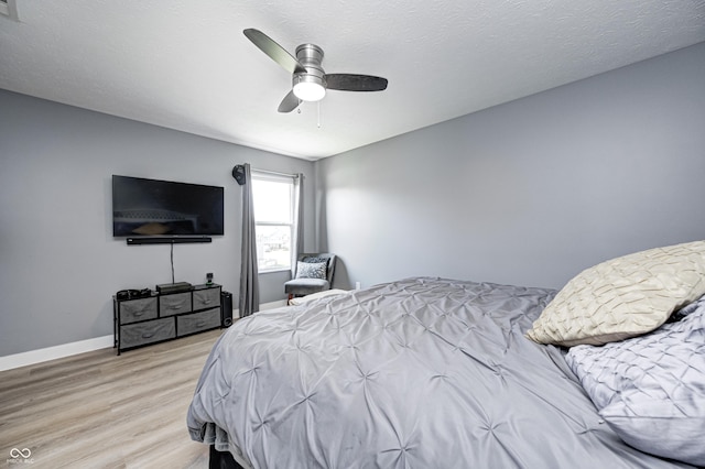 4644 Shelby Cir, Greenwood, IN 46143 - bedroom with light wood finished floors, baseboards, and ceiling fan
