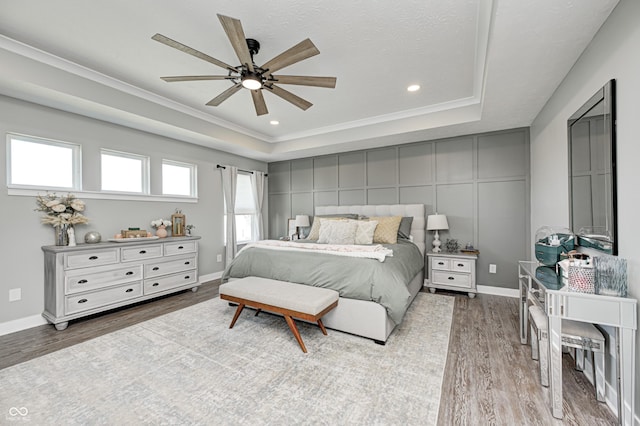 4644 Shelby Cir, Greenwood, IN 46143 - bedroom featuring recessed lighting, a tray ceiling, crown molding, and wood finished floors