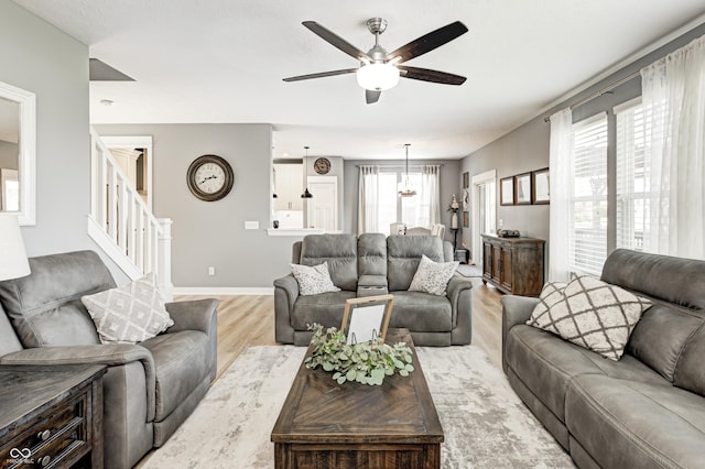 4644 Shelby Cir, Greenwood, IN 46143 - living area with ceiling fan, baseboards, wood finished floors, and stairs
