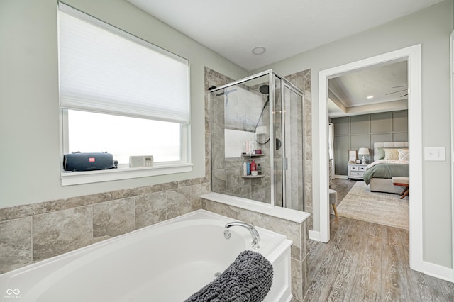 4644 Shelby Cir, Greenwood, IN 46143 - full bathroom with a stall shower, ensuite bath, wood finished floors, and a garden tub