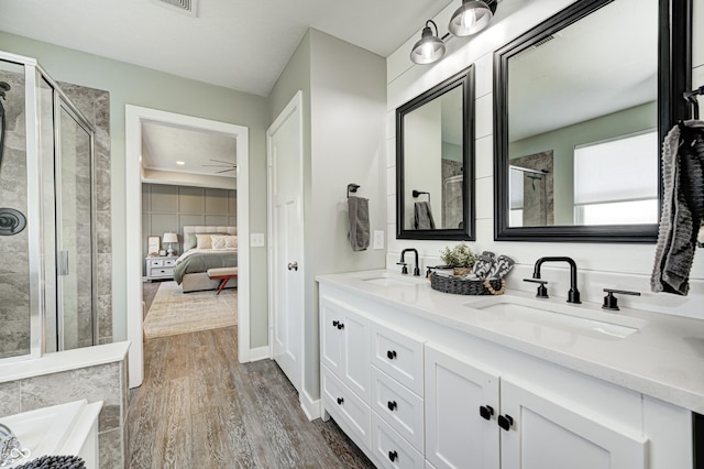4644 Shelby Cir, Greenwood, IN 46143 - bathroom featuring a shower stall, ensuite bath, a sink, and wood finished floors