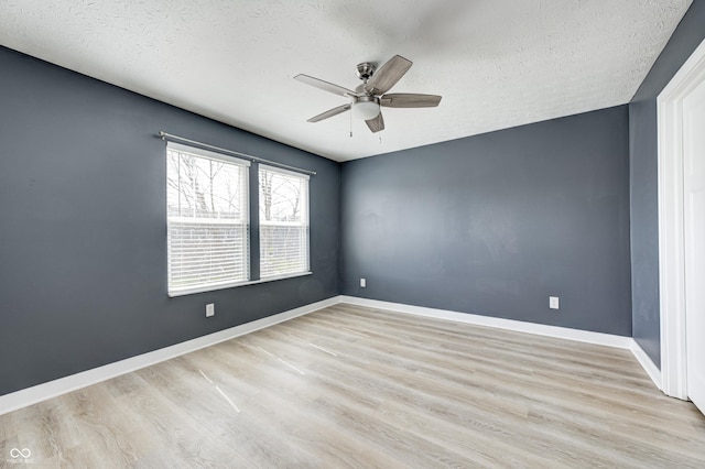 4644 Shelby Cir, Greenwood, IN 46143 - empty room with baseboards, a ceiling fan, wood finished floors, and a textured ceiling