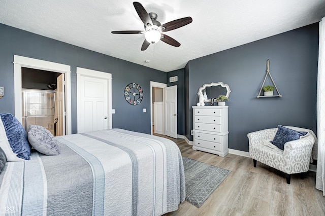 4644 Shelby Cir, Greenwood, IN 46143 - bedroom with baseboards, a ceiling fan, a textured ceiling, connected bathroom, and wood finished floors