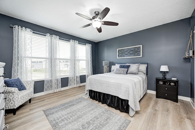 4644 Shelby Cir, Greenwood, IN 46143 - bedroom with wood finished floors, ceiling fan, and baseboards