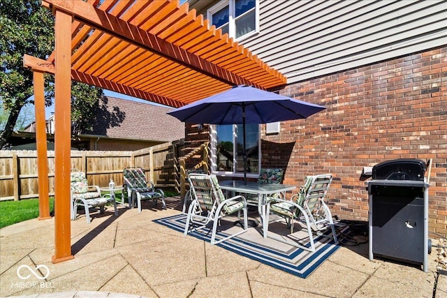 view of patio with a pergola, grilling area, fence, and outdoor dining space