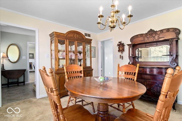 dining area featuring visible vents, baseboards, an inviting chandelier, ornamental molding, and light colored carpet