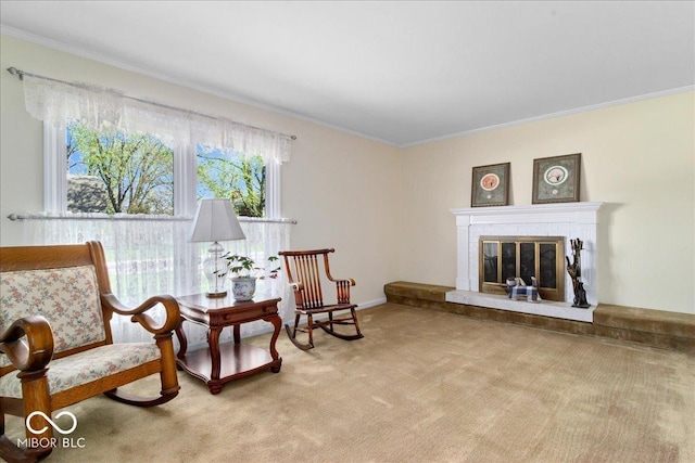 living area with ornamental molding, carpet flooring, and a brick fireplace