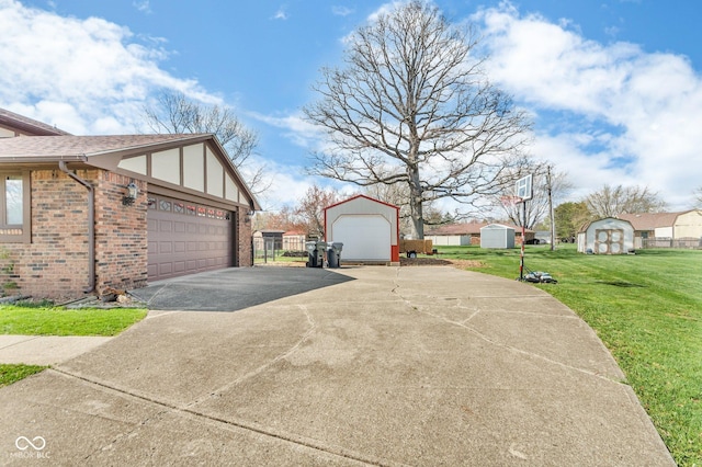 view of side of property with an outdoor structure, a lawn, brick siding, an attached garage, and driveway