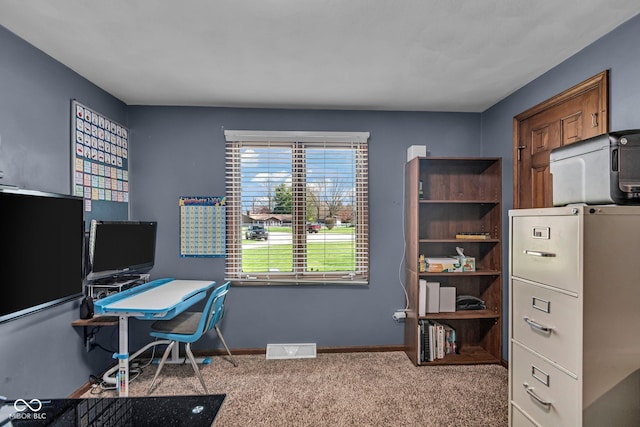 office with visible vents, baseboards, and carpet