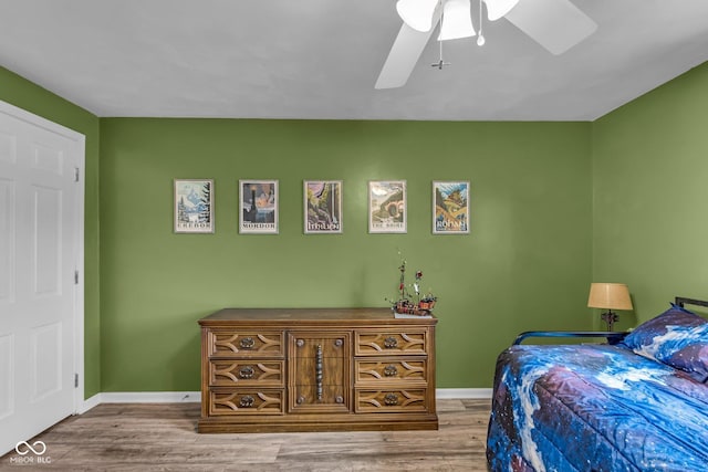 bedroom with baseboards, a ceiling fan, and wood finished floors