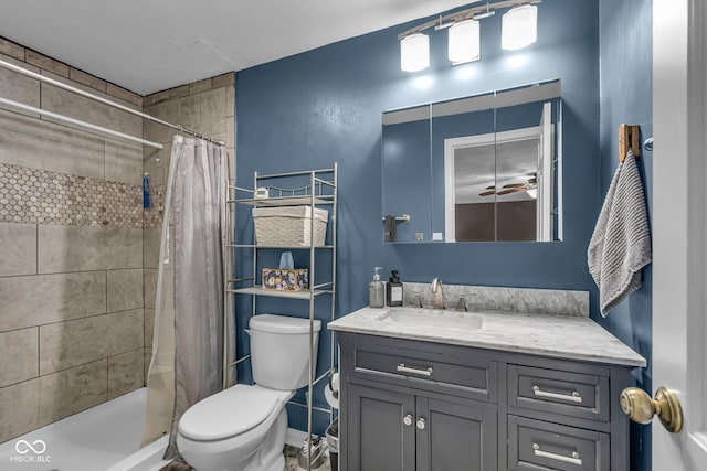 bathroom featuring toilet, vanity, and a tile shower
