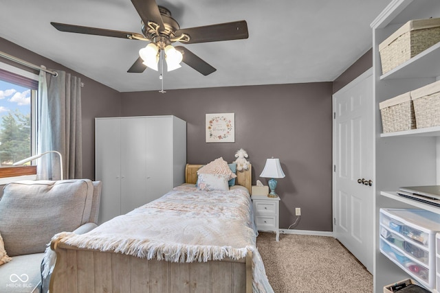 bedroom featuring baseboards, a ceiling fan, and carpet