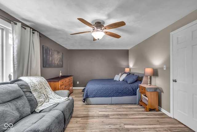 bedroom featuring wood finished floors, ceiling fan, and baseboards