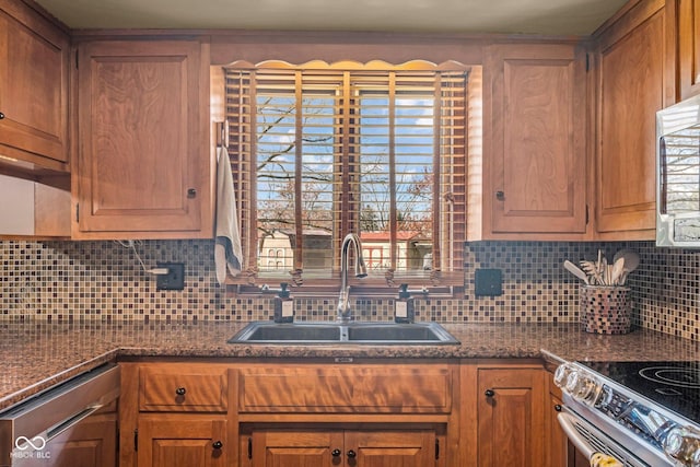 kitchen featuring stainless steel appliances, a sink, and backsplash