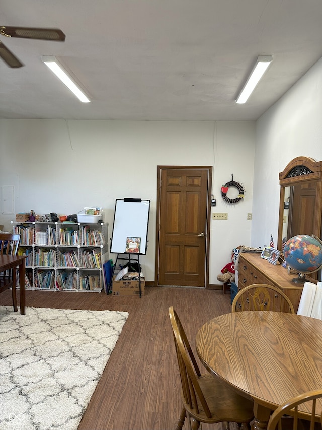 dining space with wood finished floors and a ceiling fan