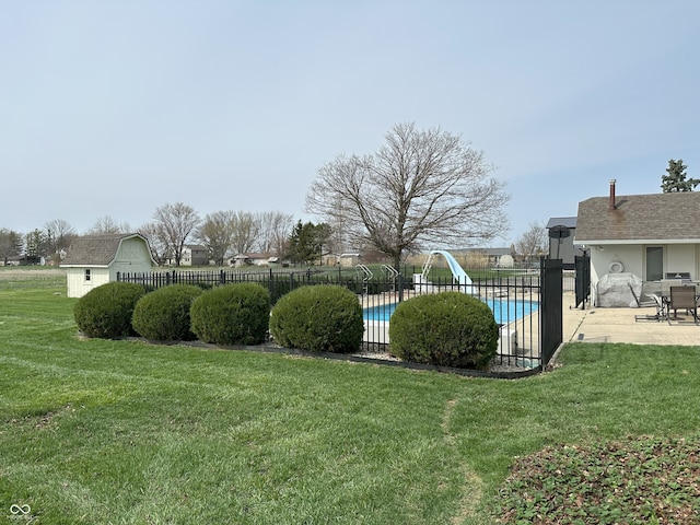 view of yard featuring a fenced in pool, a patio, and fence