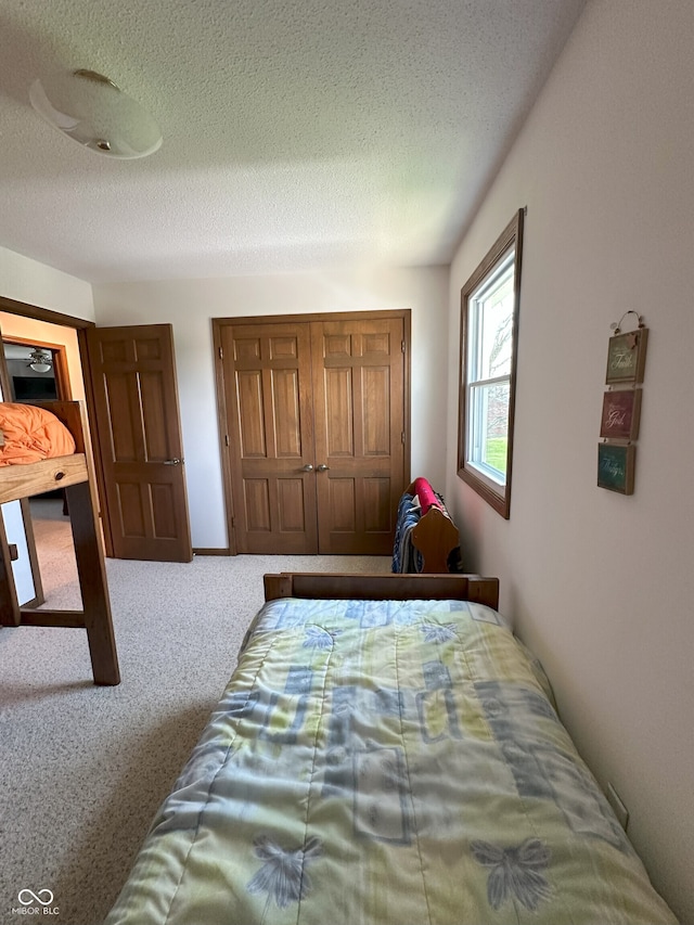 carpeted bedroom with a textured ceiling
