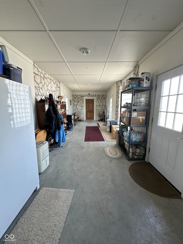 interior space with concrete flooring and a paneled ceiling