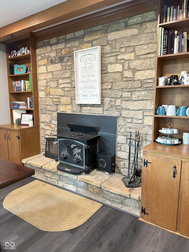 living area featuring a wood stove and wood finished floors