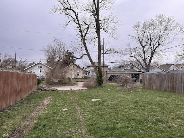 view of yard featuring fence and a residential view