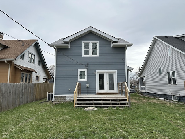 back of house with french doors, a yard, a wooden deck, and fence