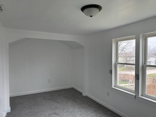 unfurnished room featuring visible vents, carpet flooring, baseboards, and plenty of natural light