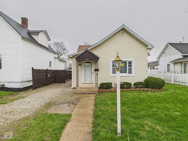 709 S A St, Elwood, IN 46036 - bungalow featuring a front lawn and fence