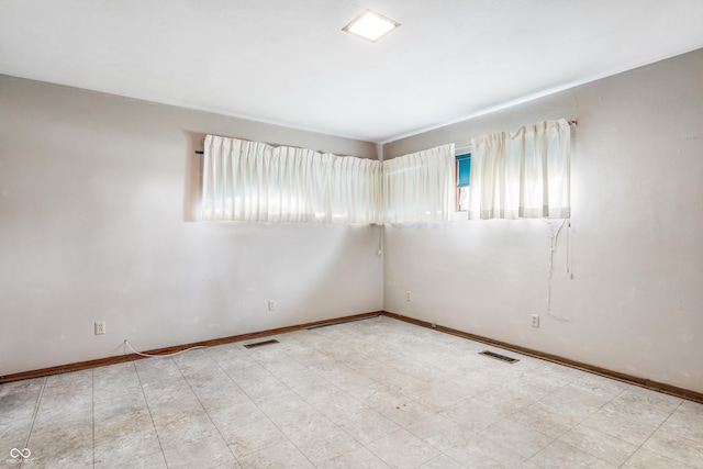 spare room with visible vents and baseboards