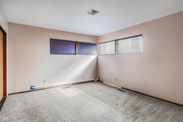 unfurnished room featuring visible vents, baseboards, and carpet flooring