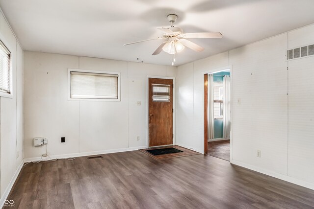 foyer entrance featuring wood finished floors, baseboards, a ceiling fan, and visible vents