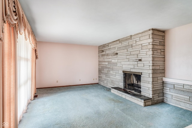 unfurnished living room with a fireplace and carpet