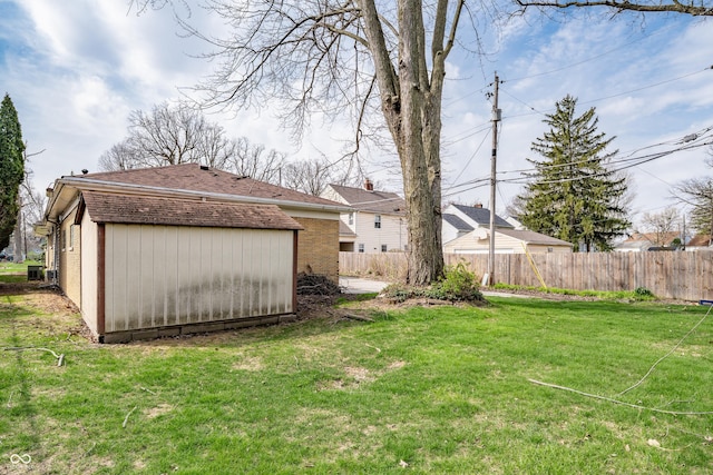 view of yard with an outdoor structure and fence