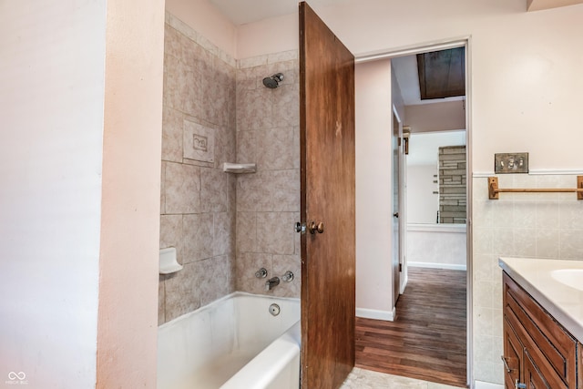bathroom featuring wood finished floors, vanity, and shower / bathtub combination