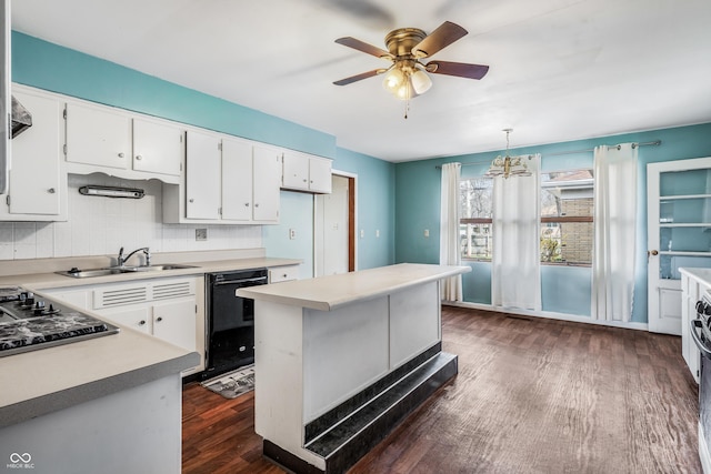 kitchen with white cabinets, dishwasher, a sink, light countertops, and dark wood-style floors
