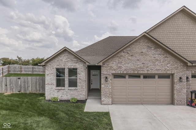 2144 Connie Ct, Franklin, IN 46131 - view of front of home with brick siding, driveway, an attached garage, and roof with shingles