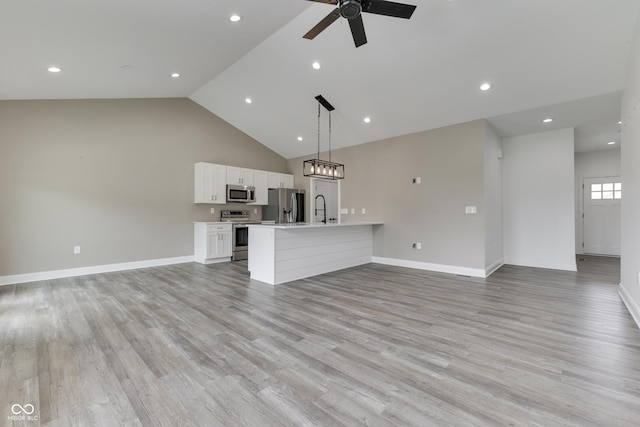 2144 Connie Ct, Franklin, IN 46131 - unfurnished living room featuring a ceiling fan, light wood-style floors, a sink, baseboards, and high vaulted ceiling