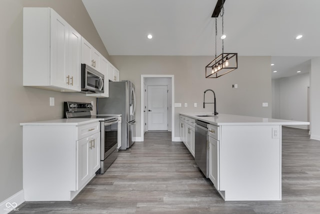 2144 Connie Ct, Franklin, IN 46131 - kitchen with appliances with stainless steel finishes, a sink, baseboards, light wood-style floors, and white cabinetry