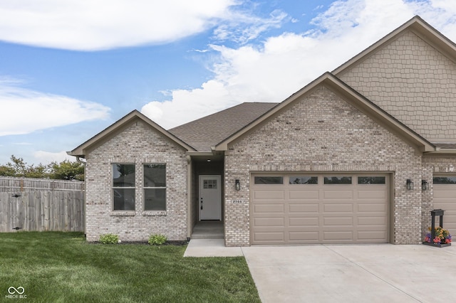 2144 Connie Ct, Franklin, IN 46131 - view of front facade featuring brick siding, driveway, a garage, and a shingled roof