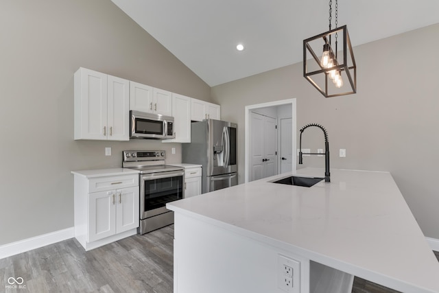 2144 Connie Ct, Franklin, IN 46131 - kitchen featuring stainless steel appliances, a sink, white cabinetry, light wood-style floors, and light countertops