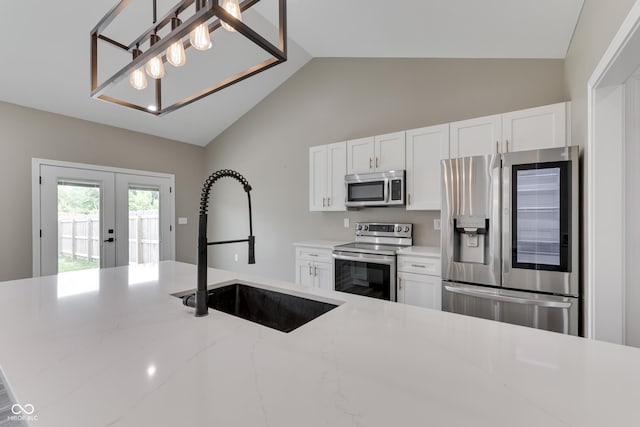 2144 Connie Ct, Franklin, IN 46131 - kitchen with stainless steel appliances, a sink, french doors, vaulted ceiling, and white cabinets